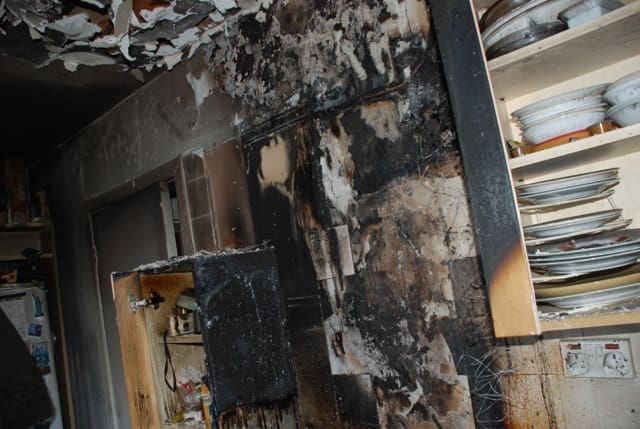 Fire damage to ceiling and kitchen units caused by chip pan fire