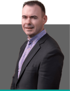 Portrait of the Managing Director of Insurance Claim Solutions, wearing a dark suit and checked shirt