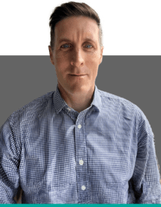 Headshot of John Holland, a team member at Insurance Claim Solutions, wearing a blue checked shirt.