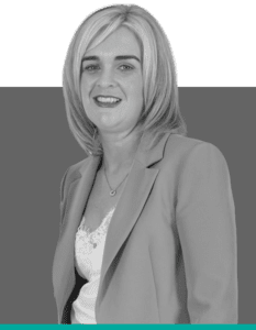 Black-and-white headshot of Collette, a staff member at Insurance Claim Solutions, wearing a blazer.