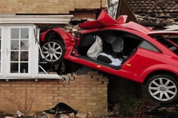 an image of a car crashed intro a residential property , image was made for what does a loss adjuster do news post