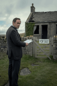 insurance claim solution staff memeber looking at damaged irish building